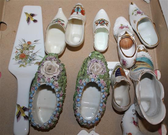 Pair of Continental porcelain clogs, flower-encrusted & seven porcelain shoe ornaments, some crested